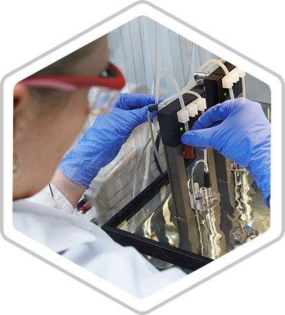 A technician adjusts tubes on a machine