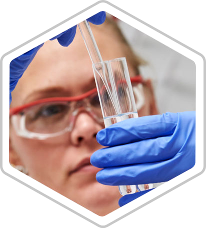 A technician pipettes liquid into a test tube